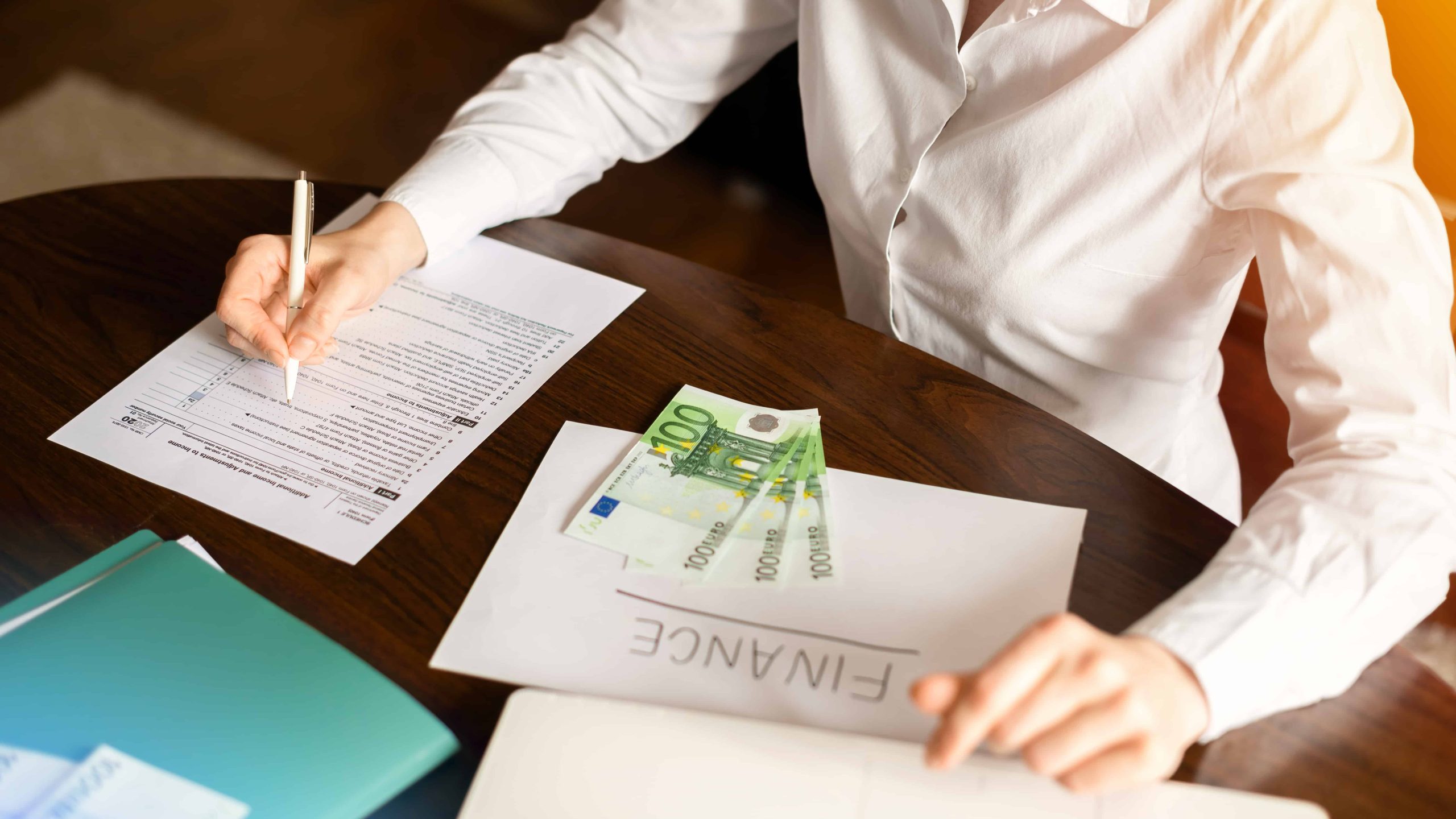 woman-working-with-finances-table-money-papers